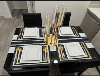 a black and white table with black and gold furniture at Luxury Haven by Kc & Flo in Calgary