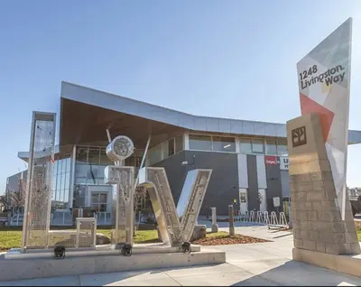 a building with a sculpture in front of it at Luxury Haven by Kc & Flo in Calgary