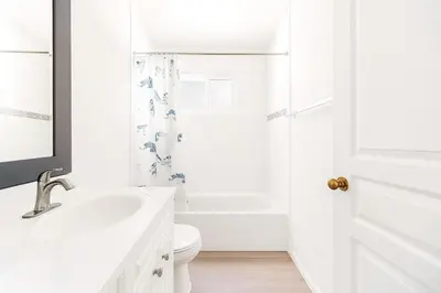 a white bathroom with a sink and a toilet at Sweet 2-bedrooms house in Vancouver in Vancouver