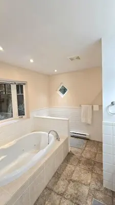 a large bathroom with a tub and a window at Spacious & Cozy House Near Lonsdale, Peaceful North Vancouver Stay in North Vancouver