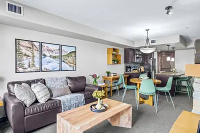 a living room with a couch and a table at Rockies Getaway 2BR with Patio Hot Tub and Gym in Dead Man's Flats