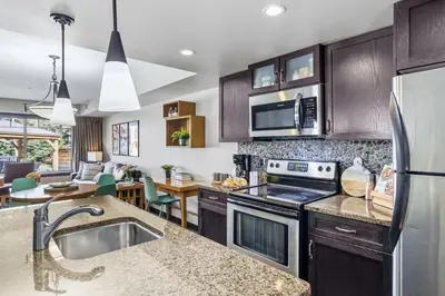 a kitchen with a sink and a stove top oven at Rockies Getaway 2BR with Patio Hot Tub and Gym in Dead Man's Flats