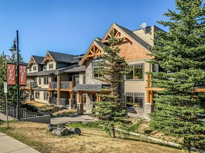 a large house with a tree in front of it at Rockies Getaway 2BR with Patio Hot Tub and Gym in Dead Man's Flats