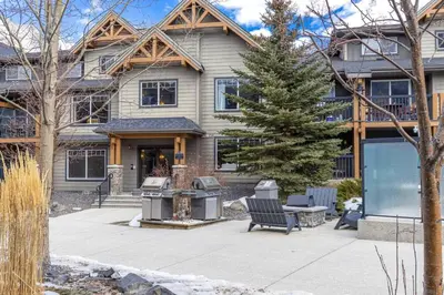 a house with a fire grill in front of it at Contemporary 2BR with hot tub and Mountain Views in Dead Man's Flats