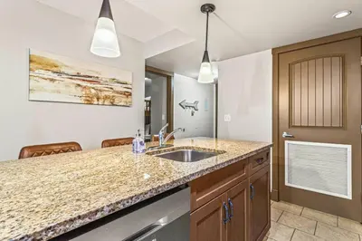 a kitchen with a sink and a counter at Contemporary 2BR with hot tub and Mountain Views in Dead Man's Flats