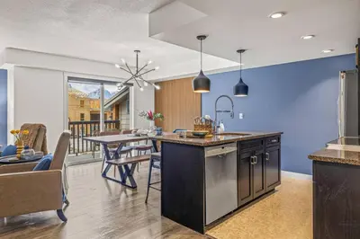 a kitchen and dining room with a dining table at Amazing 3BR Condo With Hot Tub Access and Mtn Views in Dead Man's Flats