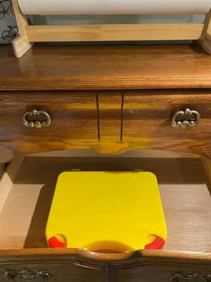 a yellow drawer in a wooden dresser at New! Spacious Bright Home in GREAT Location in Red Deer