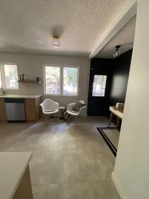 a living room with two chairs and a table at New! Spacious Bright Home in GREAT Location in Red Deer