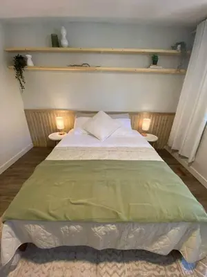 a bedroom with a large bed with two tables at New! Spacious Bright Home in GREAT Location in Red Deer
