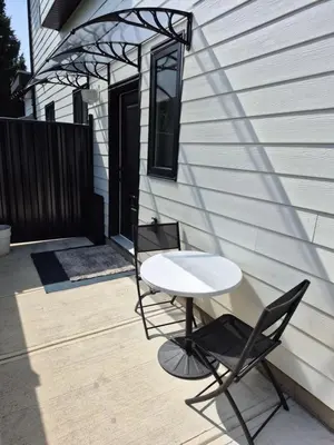 a table and two chairs sitting on a patio at Sunny Skies Suites in Surrey