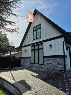 a house with a flag on the side of it at Sunny Skies Suites in Surrey