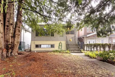 a house with stairs in front of it at Newly Renovated Cozy Guest House In Joyce-Collingwood in Vancouver