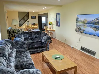 a living room with a couch and a table at Dragon's End Guesthouse in Massett