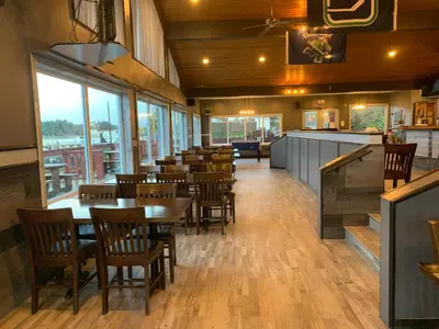 a dining room with tables and chairs in a restaurant at Island West Resort-Motel in Ucluelet