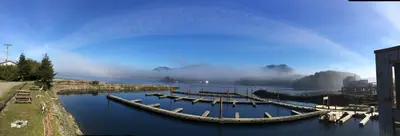 a group of boats are docked in a river at Island West Resort-Motel in Ucluelet