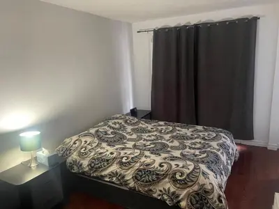 a bedroom with a bed and a window with a curtain at Large Farm in Bélanger