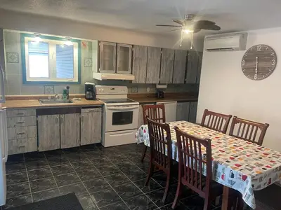 a kitchen with a table and chairs and a kitchen with a sink at Large Farm in Bélanger