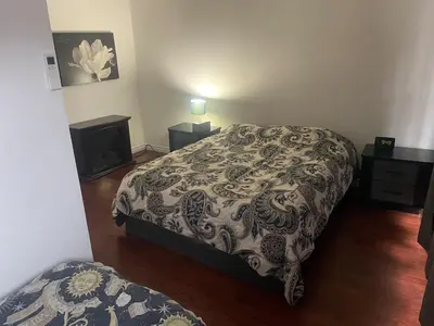 a bedroom with a bed and a fireplace in it at Large Farm in Bélanger