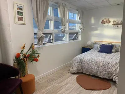 a bedroom with a bed and a window at ArtHaus Downtown Jim Robb Unit 3BR 3BA in Whitehorse
