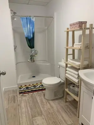 a bathroom with a tub and a toilet and a sink at ArtHaus Downtown Jim Robb Unit 3BR 3BA in Whitehorse
