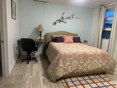 a bedroom with a bed and a desk and a chair at ArtHaus Downtown Jim Robb Unit 3BR 3BA in Whitehorse