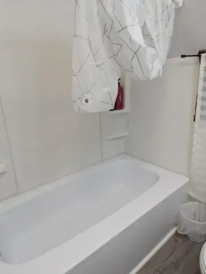 a bathroom with a white tub and a shower curtain at 347 Des Meurons Street Unit A and Unit B in Bélanger