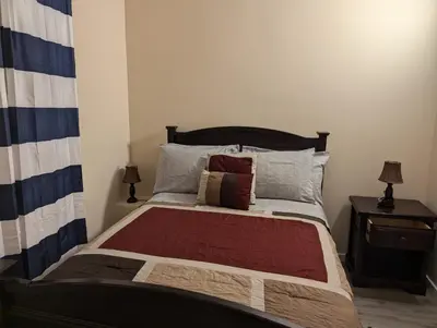 a bedroom with a large bed with two lamps at 347 Des Meurons Street Unit A and Unit B in Bélanger