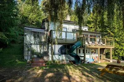 a house with a slide in front of it at The Mushroom Manor B&B and Cedar Sauna in Salt Spring Island