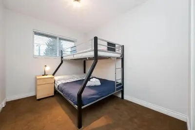 a bedroom with two bunk beds in a room at Cozy 3BR Family Home near City Centre & SkyTrain in Coquitlam