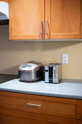 a slow cooker and a toaster on a kitchen counter at Cozy 3BR Family Home near City Centre & SkyTrain in Coquitlam