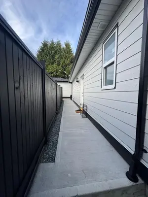 a walkway next to a house with a fence at Brand new fully Private Garden suite 2 in Delta