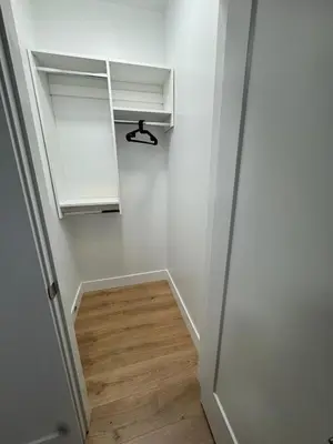 a hallway with white cabinets and a wooden floor at Brand new fully Private Garden suite 2 in Delta