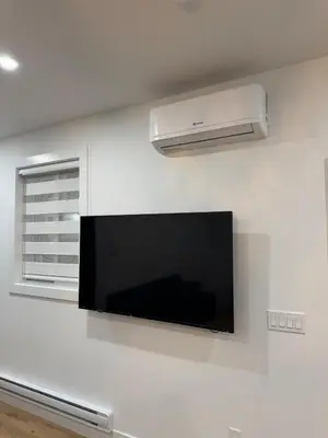 a flat screen tv hanging on a white wall at Brand new fully Private Garden suite 2 in Delta