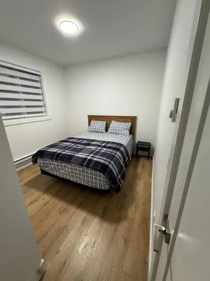 a bedroom with a bed and a wooden floor at Brand new fully Private Garden suite 2 in Delta