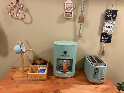 a coffee maker and a toaster on a wooden table at A Room of One's Own-A perfect getaway by the sea in North Nanaimo in Nanaimo