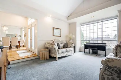 a living room with a couch and a piano at Surrey Nature Retreat 4BDR Home in Surrey