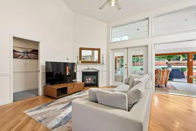 a living room with a couch and a fireplace at Surrey Nature Retreat 4BDR Home in Surrey
