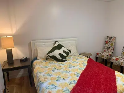 a bedroom with a bed with a cow pillow on it at ArtHaus Downtown Emma Barr Unit 3BR 1BA in Whitehorse