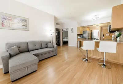 a living room with a couch and a kitchen at Cozy Canmore 2-Bedroom Retreat in Canmore