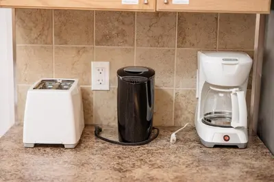 a kitchen counter with a coffee maker and a blender at Cozy Canmore 2-Bedroom Retreat in Canmore