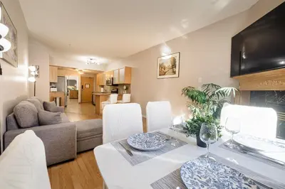 a living room and dining room with a table and chairs at Cozy Canmore 2-Bedroom Retreat in Canmore