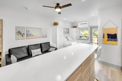 a living room with a white counter and a couch at Vita Resort Vernon - Modern Studio on Okanagan Lake in Vernon