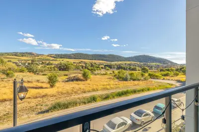 a view from a balcony with cars parked on a road at Vita Resort Vernon - Modern Studio on Okanagan Lake in Vernon