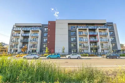 a parking lot with cars parked in front of a building at Vita Resort Vernon - Modern Studio on Okanagan Lake in Vernon