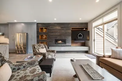 a living room with a couch and a fireplace at Englewood Greens 40 by Outpost Whistler in Whistler