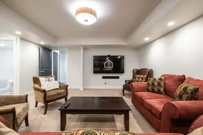 a living room with a couch and chairs and a tv at Englewood Greens 40 by Outpost Whistler in Whistler