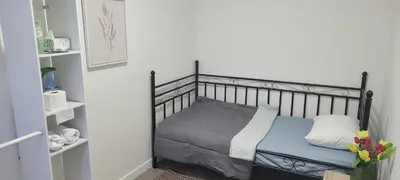 a bedroom with a bed with a metal frame at Single Court in Abbotsford