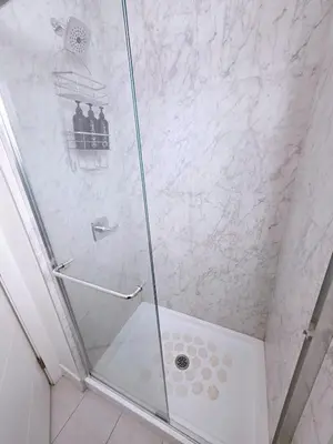 a shower stall with a glass shower door at New Langford Suite near Lake & Mall, Free Parking in Goldstream Station