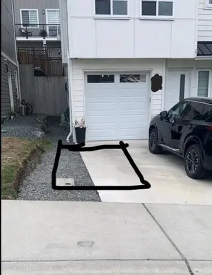 a black object on the ground in front of a garage at New Langford Suite near Lake & Mall, Free Parking in Goldstream Station