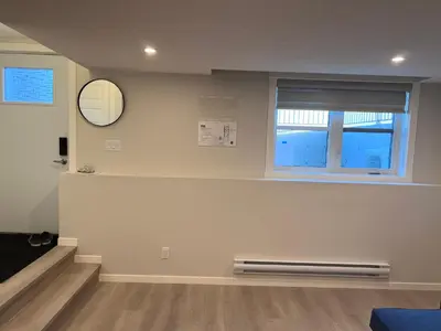 a living room with a bench and a window at The Lakefront - A new 2-bedroom in Mahogany Calgary in Calgary